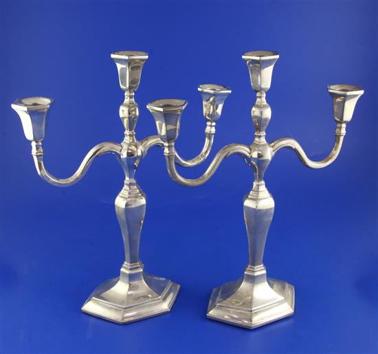 A pair of 20th century Chinese silver two branch, three light candelabra by Wai Kee, Hong Kong, weighted.